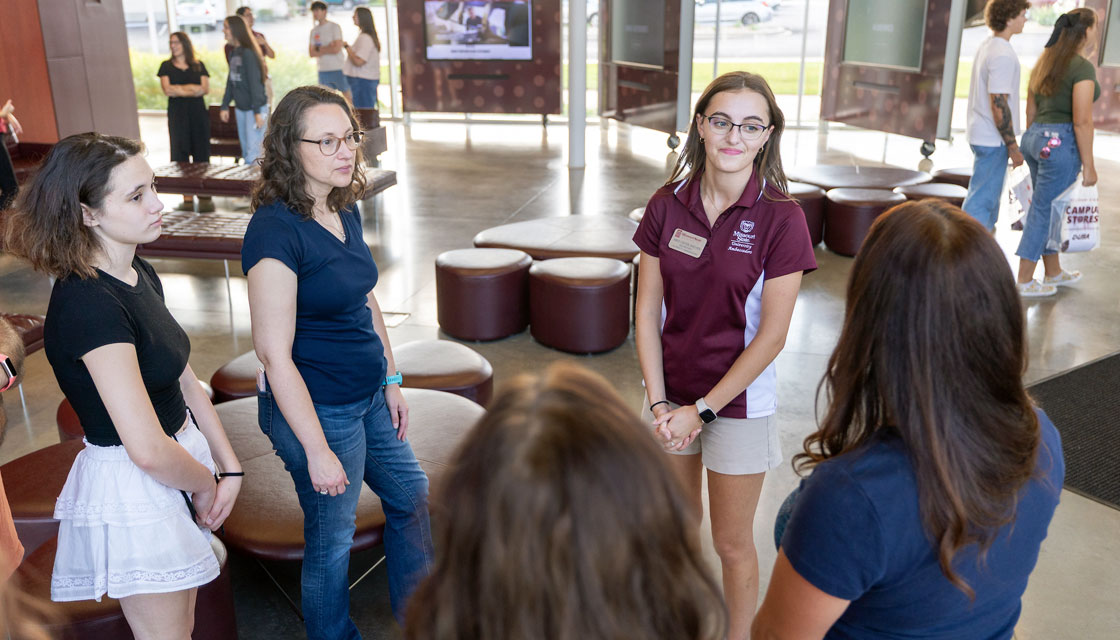 Missouri State tour guide addressing a group of students during a guided tour